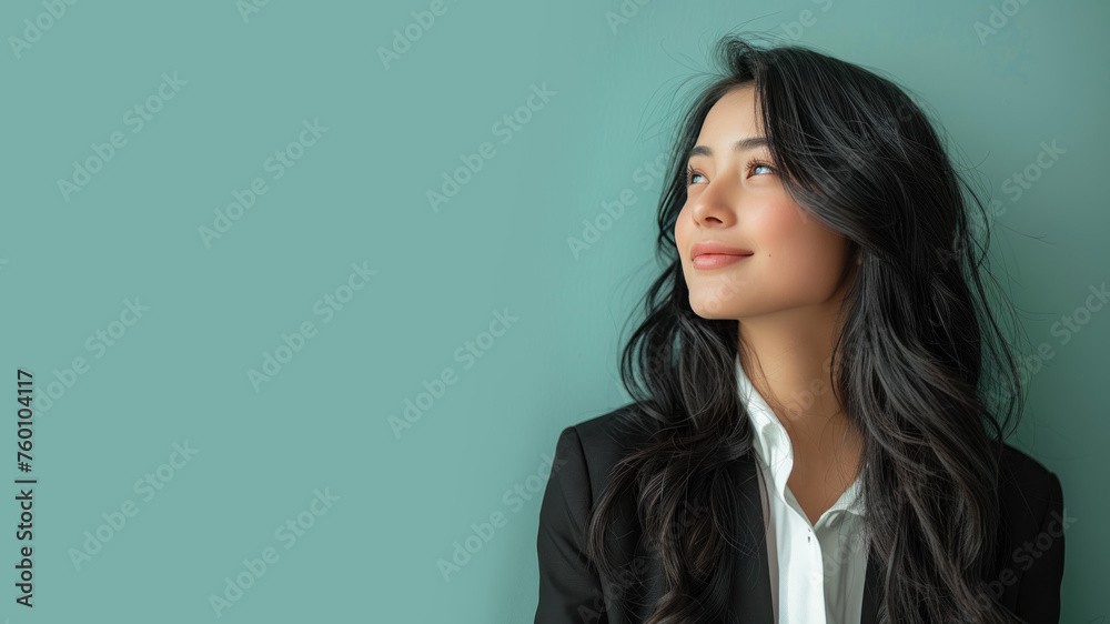 Malay businesswoman in black formal suit smiling isolated on pastel Malay businesswoman in black formal suit smiling isolated on pastel