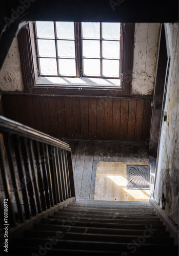 Interior of an old  wooden  pre war  neglected staircase in residential building. Daytime. No people.