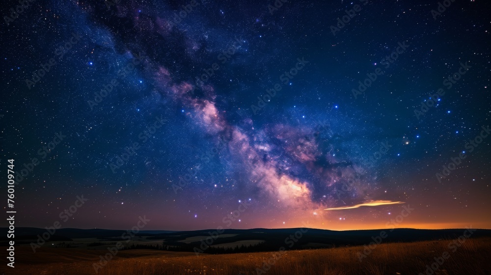 The serene landscape under a rich star-filled sky with a hint of the Milky Way's presence