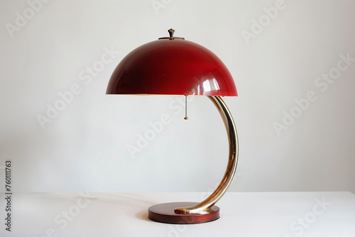 Picture the retro lamp's striking crimson lampshade against a white background, radiating timeless charm. photo