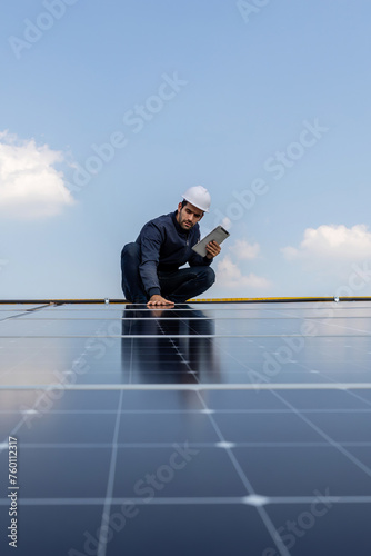 Engineer service check installation solar cell on the roof of factory. Engineers walking on roof inspect and check solar cell panel. Engineer working inspection installation solar cell on the roof © kanpisut