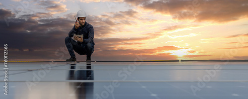 Engineer service check installation solar cell on the roof of factory. Engineers walking on roof inspect and check solar cell panel. Engineer working inspection installation solar cell on the roof photo