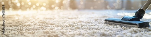 Vacuum cleaner in use on a white fluffy carpet. Thorough rug cleaning. Vacuuming. Concept of household chores, home hygiene, carpet grooming, and professional cleaning service. Wide Banner. Copy space