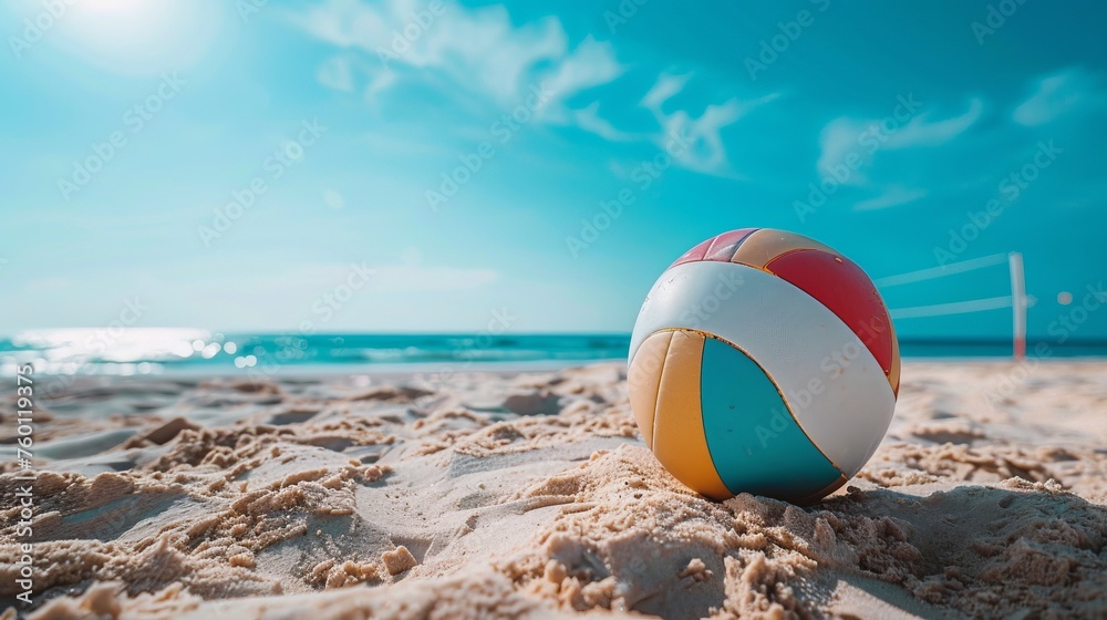 Colorful volleball ball lying on sunny beach near sea or ocean. Beach Volleyball ball on beach sand