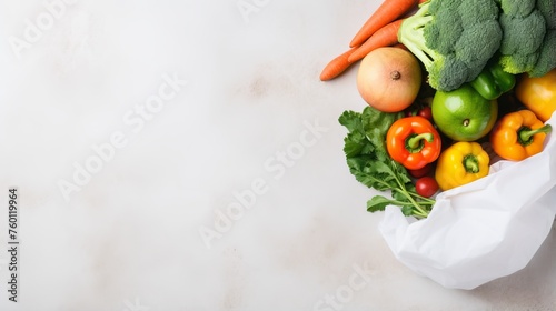 Colorful fresh produce arranged neatly in a white bag against a bright background, showcasing variety and health