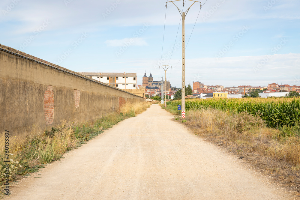 French Way of Saint James - a gravel road with a view of Astorga city, province of Leon, Castile and Leon, Spain