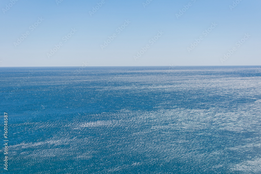 Sea ideal serene landscape - on the distant horizon the blue clear sky and the blue calm sea converge Sea ideal serene landscape - on the distant horizon the blue clear sky and the blue calm sea converge