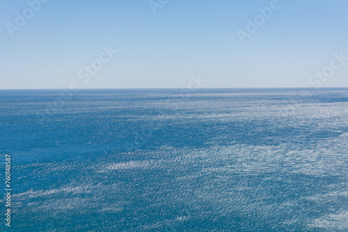 Sea ideal serene landscape - on the distant horizon the blue clear sky and the blue calm sea converge
