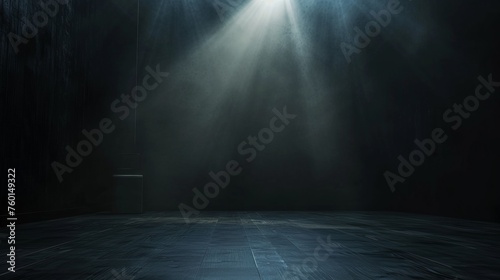 A single beam of light cuts through the darkness in this empty room, suggesting secrecy or discovery photo