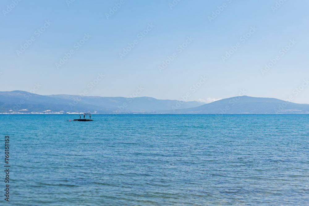 People on an island in the middle of the sea swim, bathe, have fun