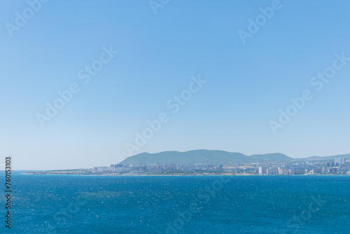 Obraz na płótnie Sea horizontal landscape - blue sky, blue sea, mountain hills on the horizon w salonie