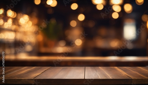 Restaurant setting: Empty wood table with soft golden bokeh lights in a darkened environment © ibreakstock