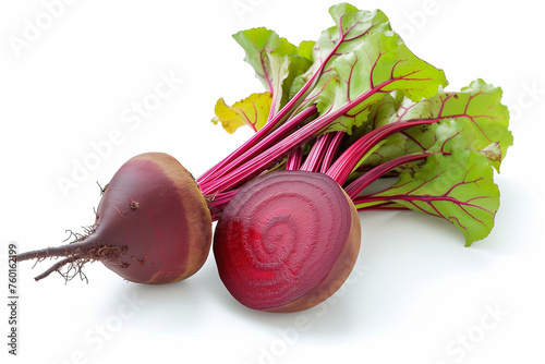 Fresh and juicy red beet root with leaves and a half isolated on white background photo