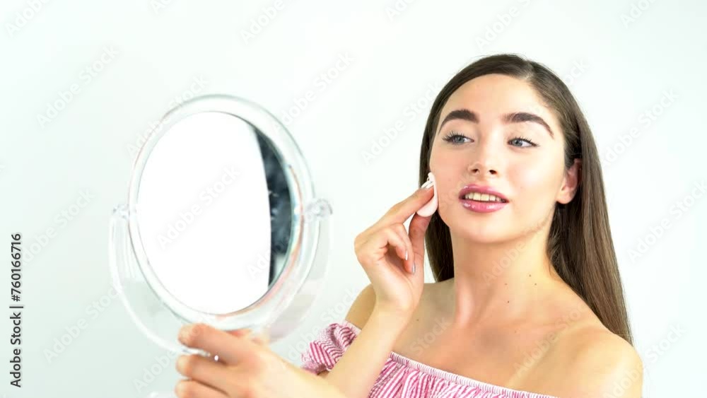 Beautiful blonde woman removing makeup from her face Beautiful blonde woman removing makeup from her face