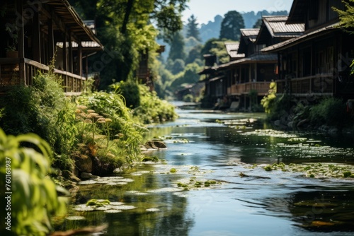 River flowing amidst trees and houses in a scenic village setting