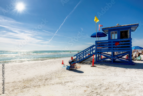 Lifeguard hut on Sunny Siesta Key Beach in a beautiful summer day with ocean and blue sky.