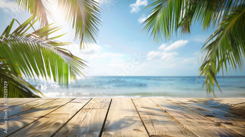 Top of wood table with seascape and palm leaves  blur bokeh light of calm sea and sky at tropical beach background. Empty ready for your product display montage. summer vacation background concept