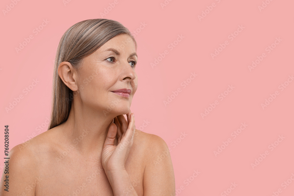 Beautiful woman touching her neck on pink background, space for text Beautiful woman touching her neck on pink background, space for text