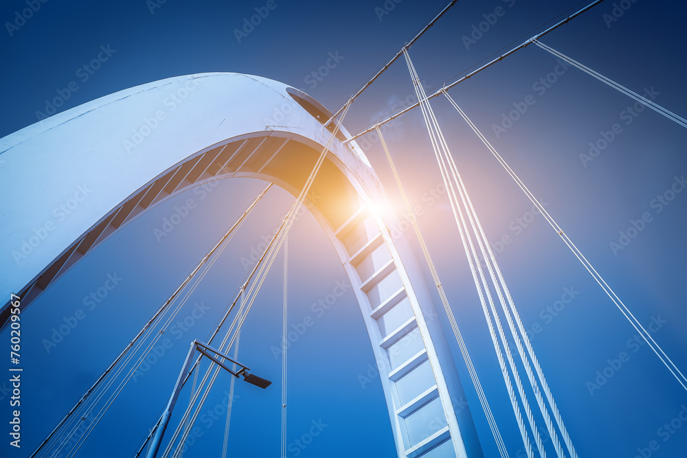 Fototapeta premium Modern Bridge Architecture Against Blue Sky with Sunflare