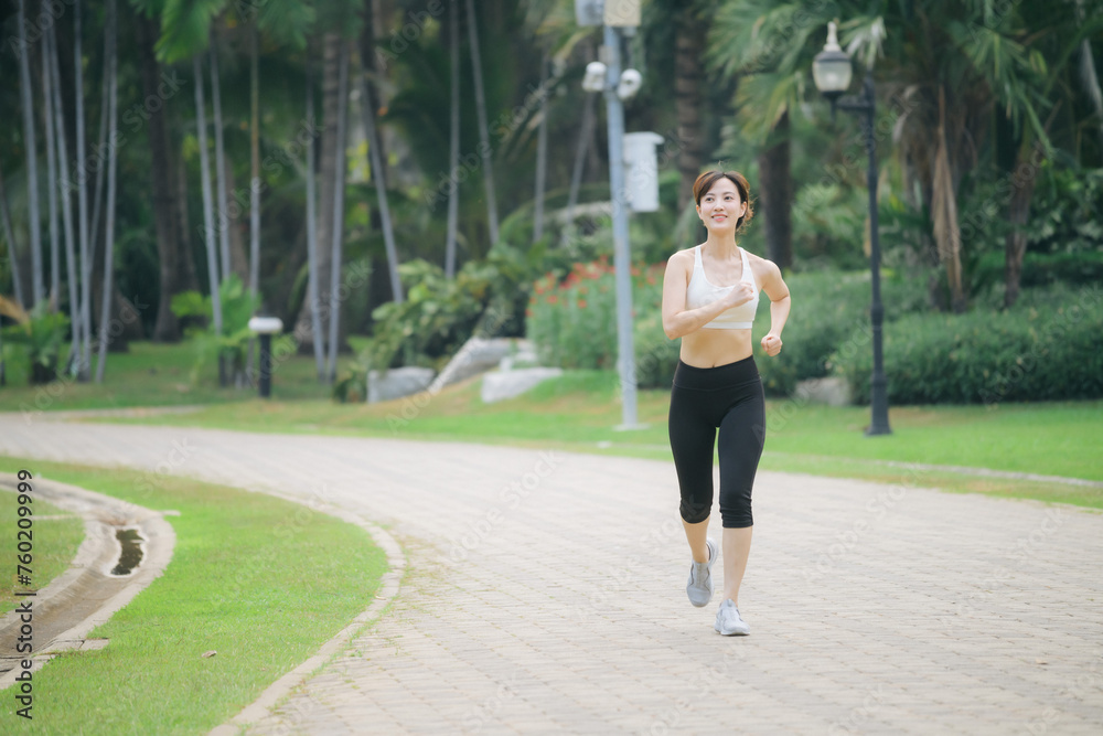 asian woman jogger running in green nature public park. asian woman jogger running in green nature public park.