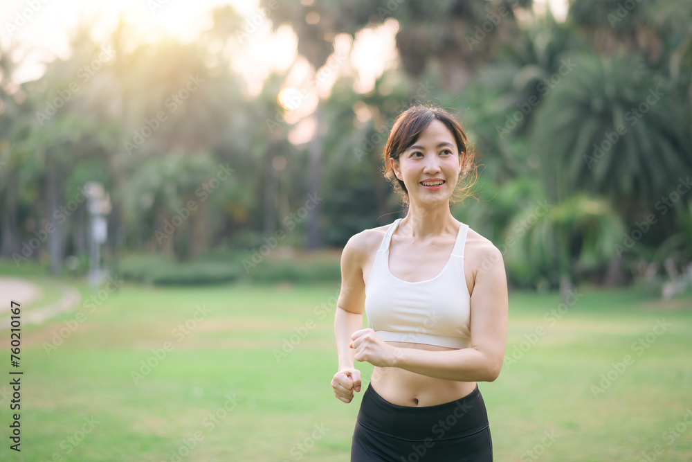 pretty asian woman jogger running in green nature public park. pretty asian woman jogger running in green nature public park.