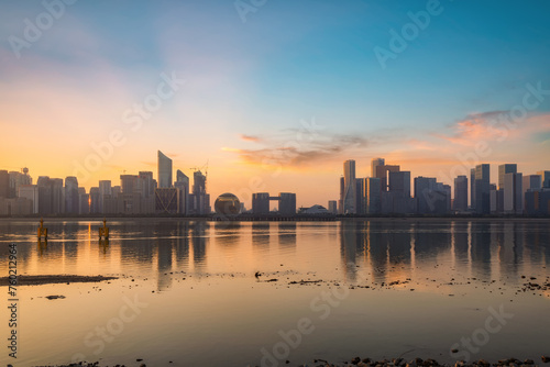 Sunset Reflection on City Skyline by the Water