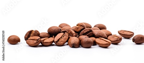 Scattered coffee beans on a clean white background - aromatic drink ingredient concept
