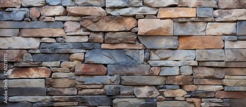 Rustic Stone Wall showcasing intricate pattern of earthy brown and tan stones