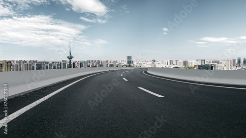 Curving Urban Highway with City Skyline View