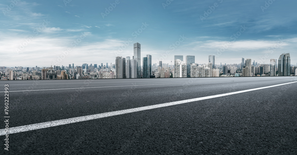 Urban Skyline and Clear Road Under Blue Sky