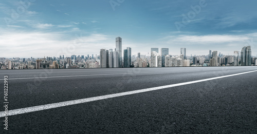 Urban Skyline and Clear Road Under Blue Sky