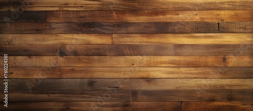 A closeup of a brown hardwood plank wall with various tints and shades  showcasing the natural pattern of the wood grain. Building material with wood stain