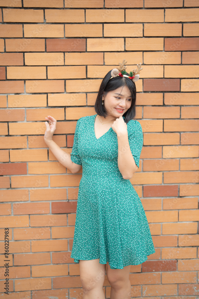 Portrait of Asian Thai woman posing in Christmas village with shops. Event holiday. Peope lifestyle