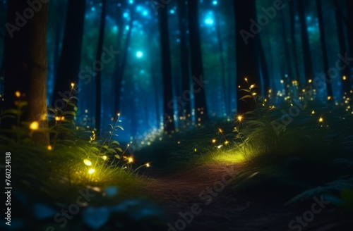 Abstract and magical image of fireflies flying in the night forest  blurred trees in background. concepts  Earth day  forest day  night adventure  fantasy forest  nature illumination  mystical path.