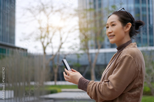 Businesswoman with Smartphone in Urban Setting