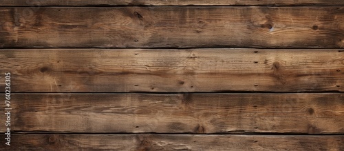 A detailed closeup of a brown hardwood wall featuring a row of wooden planks with a beautiful pattern. The wood stain enhances the natural beauty of the building material