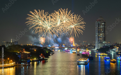Fireworks at Memorial Bridge  and Phra Pok Klao Bridge with buildings and Chao Phraya River at night. Urban city  Downtown Bangkok  Thailand.