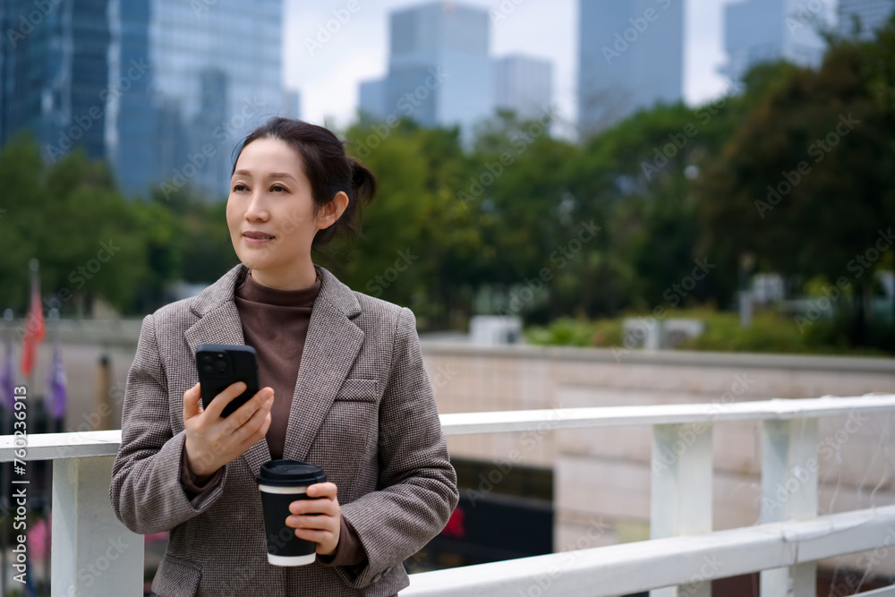 Confident Businesswoman with Smartphone in City Confident Businesswoman with Smartphone in City