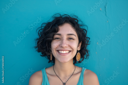 a woman with a necklace and earrings smiling