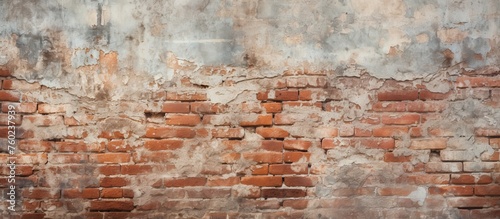 A closeup of a brown brick wall showcasing the natural landscape of building material. The brickwork and artistry contrast with the wood and soil backdrop