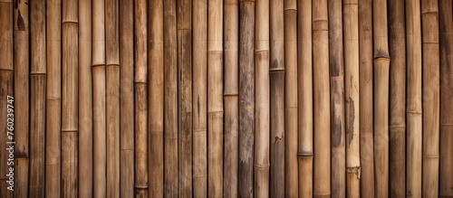 A detailed shot showcasing a patterned bamboo wall with a rich brown wood stain. The natural beauty of the hardwood planks alongside the metal fastenings creates a stunning visual