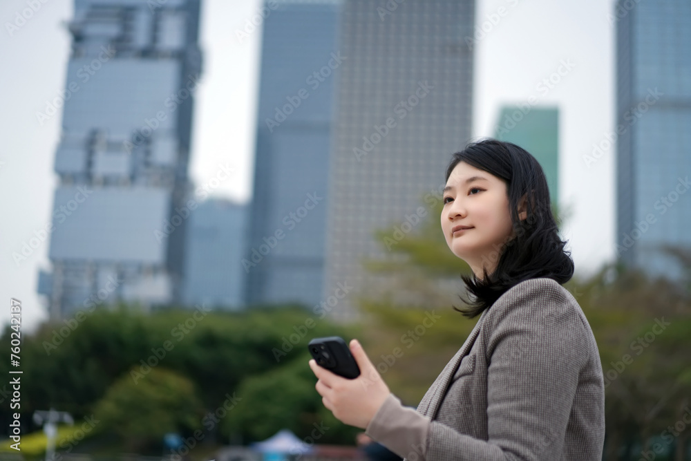 Young Professional Woman Using Smartphone in City Young Professional Woman Using Smartphone in City