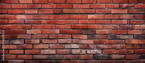 A detailed close up of a brown brick wall with rectangular windows, showcasing the intricate brickwork pattern and tints and shades of the composite material