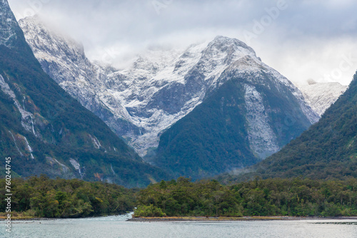 Photograph of mountains in clouds and mist viewed from the water in Milford Sound in Fiordland National Park on the South Island of New Zealand © Phillip