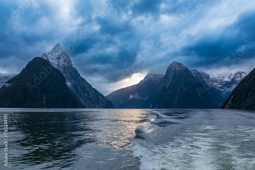 Photograph of mountains in clouds and mist viewed from the water in Milford Sound in Fiordland National Park on the South Island of New Zealand