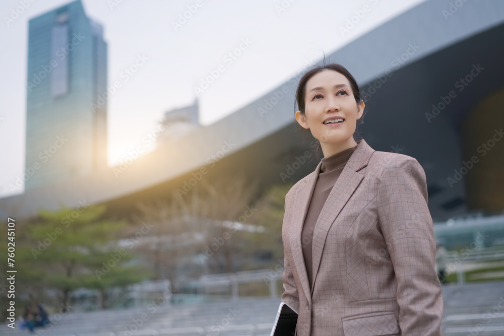 Confident Businesswoman Smiling in Urban Setting Confident Businesswoman Smiling in Urban Setting