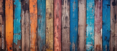 A detailed shot of a series of vibrant hardwood boards featuring a mix of magenta and electric blue hues. The intricate pattern resembles art more than flooring material