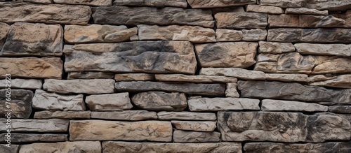 A closeup of a stone wall featuring a multitude of brown bricks, showcasing the intricate brickwork and building material used to construct the rectangular structure