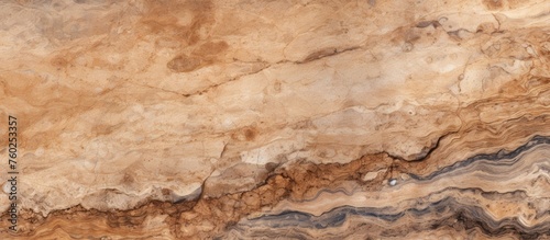 A close up of a bedrock outcrop with a marble texture, featuring a beige and brown pattern resembling hardwood flooring. The landscape showcases the natural beauty of the rock wall