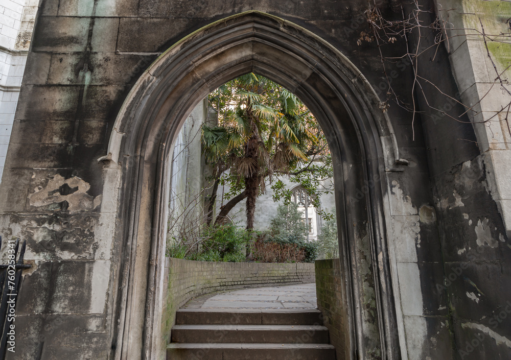 The stone arched entrance leads to the stone staircase inside of St Dunstan in the East Church Garden. The historic church was bombed and destroyed in the Second World War and is now a park, London.